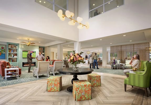 A bright common area with residents and staff interacting