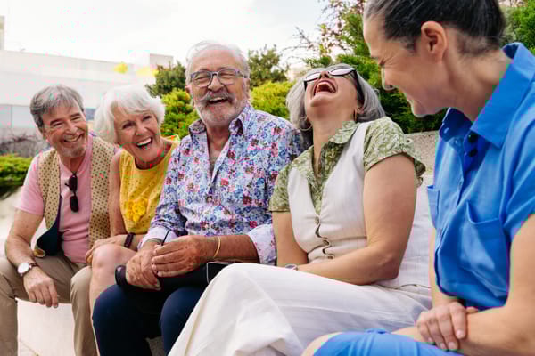 Seniors laughing and enjoying each other's company outdoors