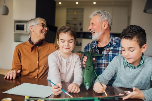 Residents and a child engaging in a fun activity indoors