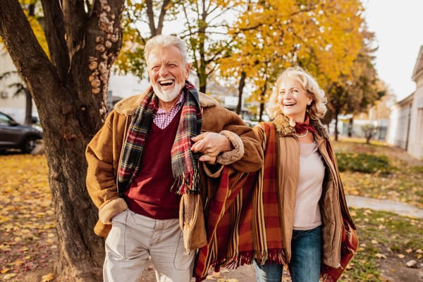 Seniors enjoying a walk outdoors in autumn