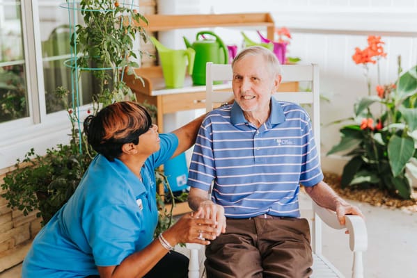 Caregiver interacting with a resident outdoors