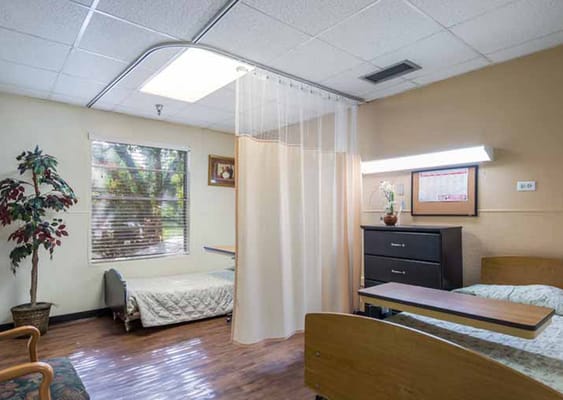 A private room in a nursing facility with two beds