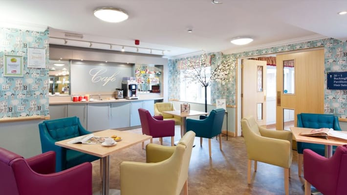 Bright common area with colorful chairs and cafe setup