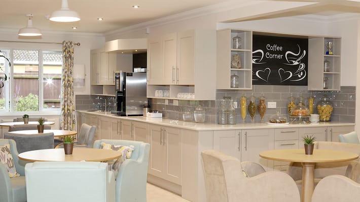 Bright common area with tables and coffee corner