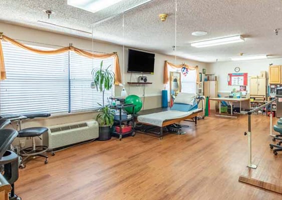Bright therapy room with equipment and windows