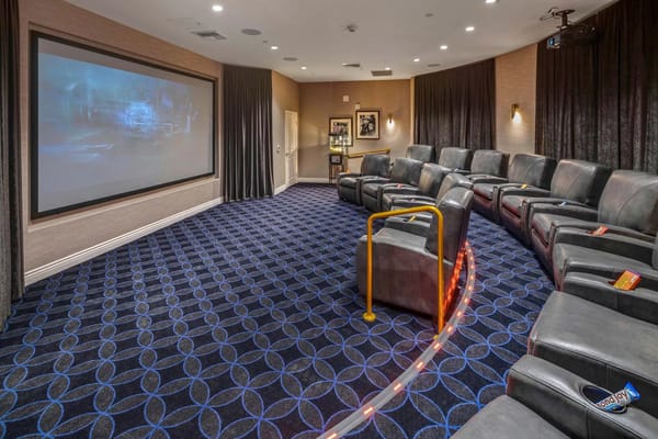 Interior theater room with comfortable seating and a large screen