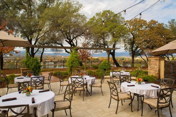 Outdoor dining area with tables and trees