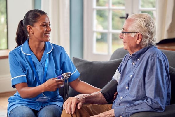 Nurse taking a resident's blood pressure