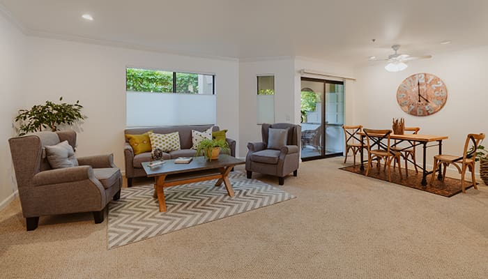 Bright and spacious common area with seating and dining table