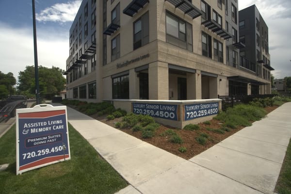 Exterior view of assisted living facility with signage