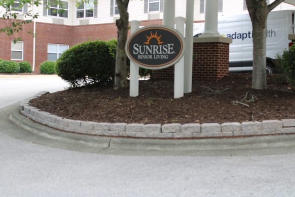 Sign for Sunrise Senior Living at the entrance