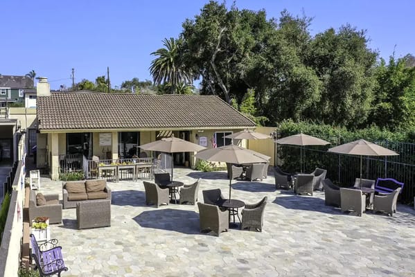 Outdoor patio area with umbrellas and seating