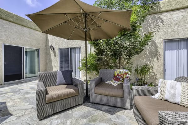 Outdoor seating area with umbrellas and plants