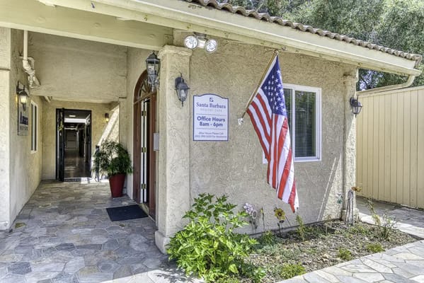 Entrance of Santa Barbara Memory Care with American flag