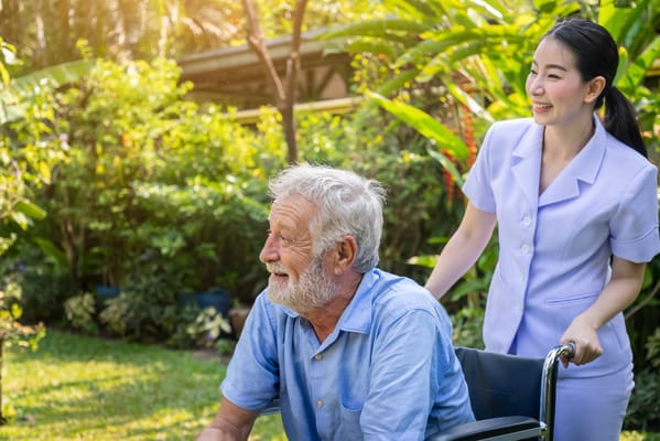 Caregiver assisting a resident in a garden