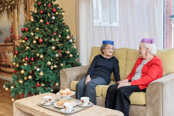 Two residents enjoying tea and conversation during Christmas