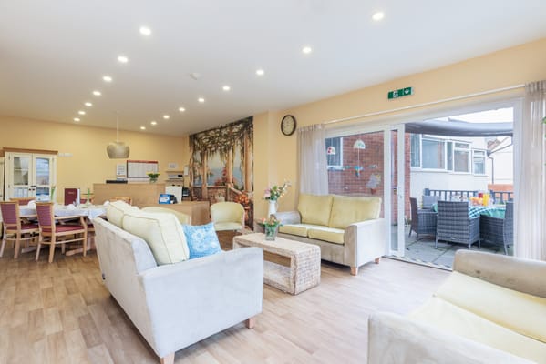 Bright common area with sofas and dining space