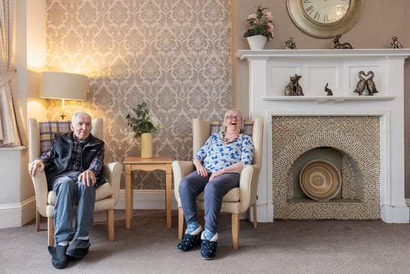 Two residents enjoying a moment in a cozy lounge area
