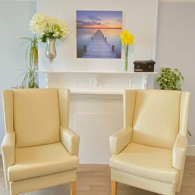 Cozy seating area with a serene artwork in the background