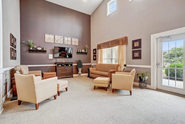 Common area with seating and decor in a senior living facility