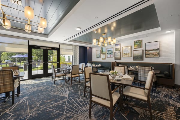 Bright dining area with tables set for residents