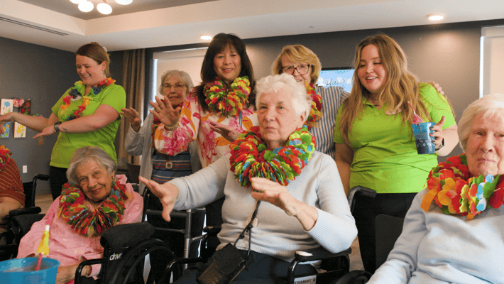 Residents and staff celebrating in a common area