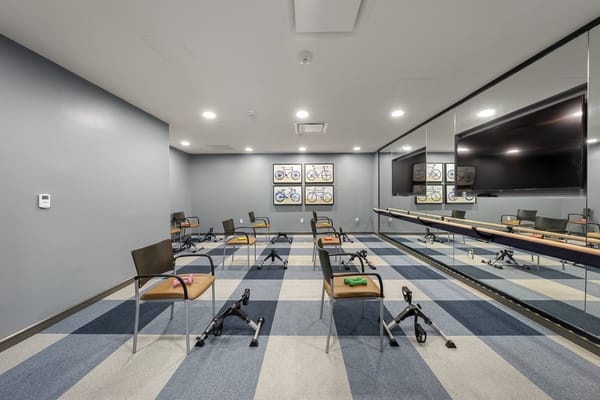 Exercise room with chairs and artwork on the wall