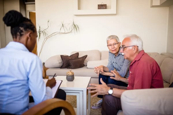 Residents engaged in a discussion with a staff member