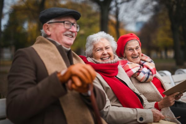 Two older adults laughing together outdoors