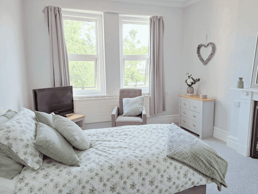 Cozy bedroom with natural light and floral bedding