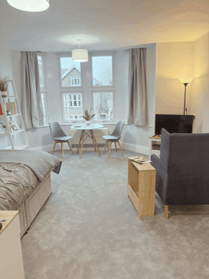 Cozy resident room with seating area and natural light