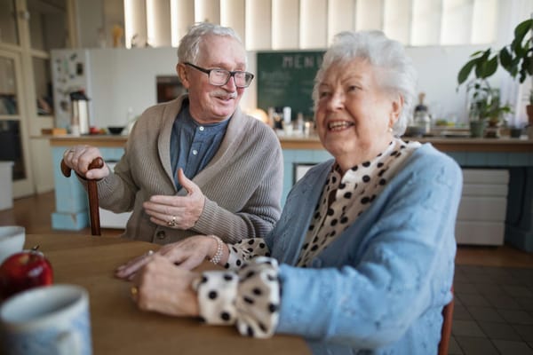 Two residents enjoying a conversation in a communal area