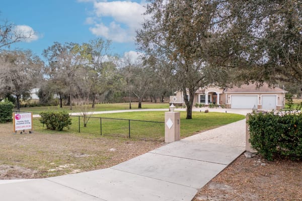 Outside view of Aliviya Rose Manor with landscaped grounds