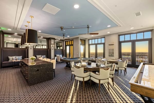 Brightly lit common area with seating and tables