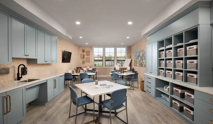 Bright common area with seating and art supplies