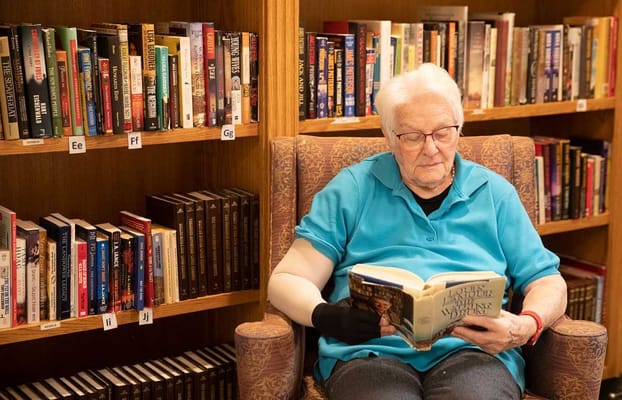 A resident reading in a library setting