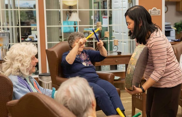 Residents engaged in a rhythmic activity session