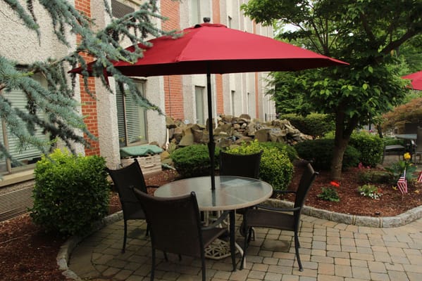 Outdoor seating area with table and umbrella