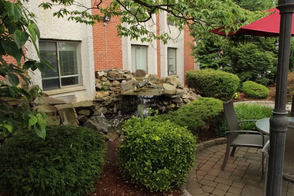 Outdoor garden area with fountain and seating