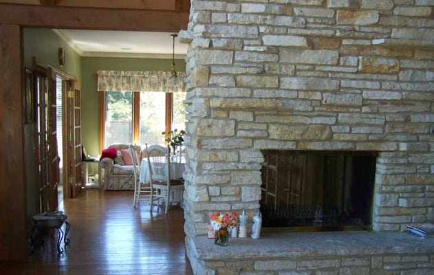 Cozy common area with a stone fireplace and seating
