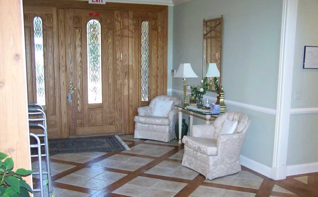 A cozy lobby area with chairs and a decorative entrance