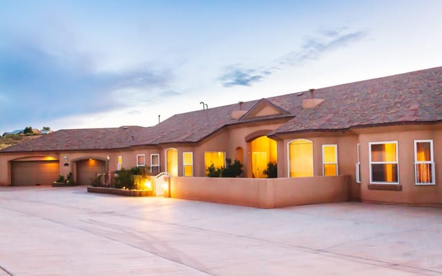 Exterior view of Casita Senior Living at dusk