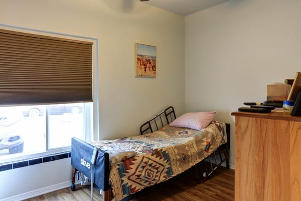 Cozy interior of a private resident room with bed and decor