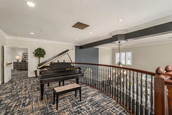 Interior view of a common area featuring a piano