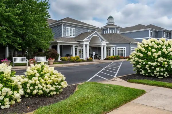Exterior view of Arcadia Senior Living with landscaped flowers