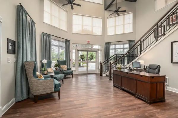 Bright lobby area with seating and a reception desk