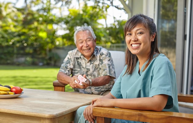 Staff member and resident smiling outdoors