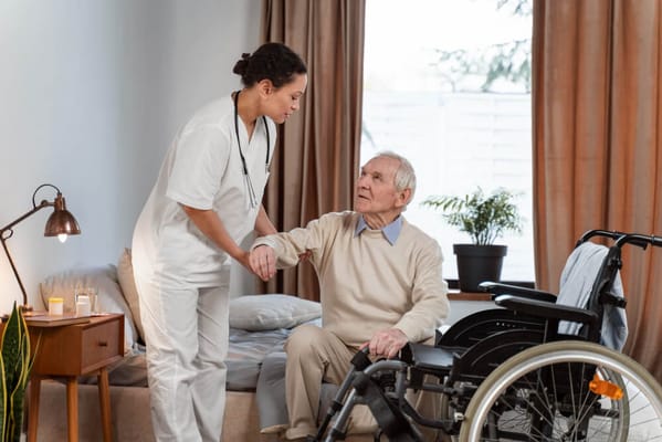 Staff assisting a resident in a facility room