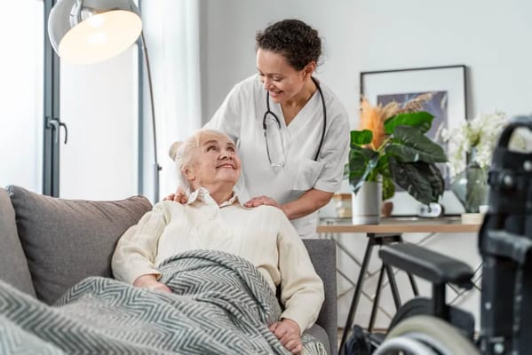 Caregiver interacting with a senior resident in a cozy living area