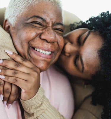 Two women smiling and sharing a joyful moment